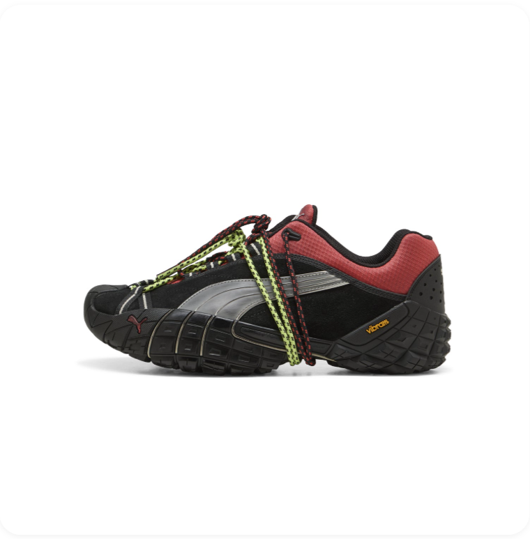 Puma Trailfox MTS Black Dark Red Lime - side profile showing translucent silver Formstripe, yellow Vibram badge and aggressive black lug traction outsole