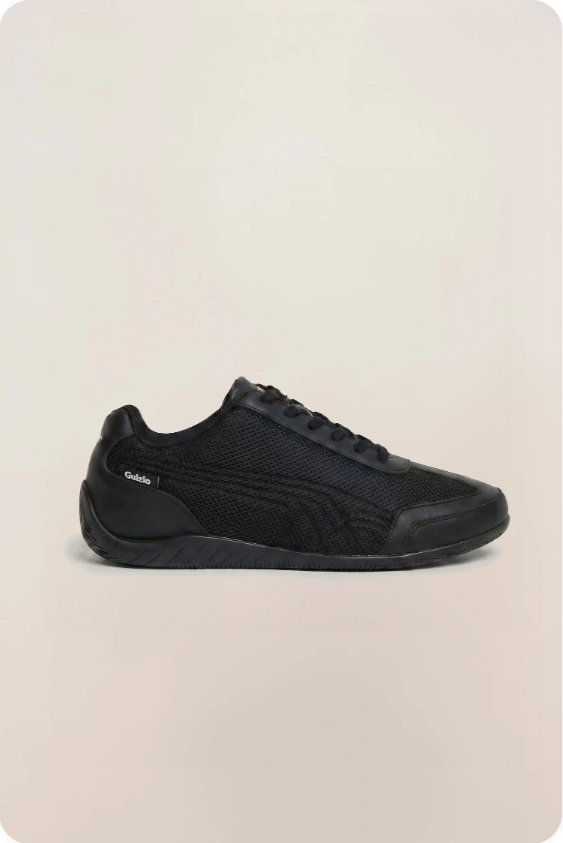Puma Speedcat Guizio Triple Black - side profile showing all-black leather upper with tonal Formstripe and Guizio co-branding script detail