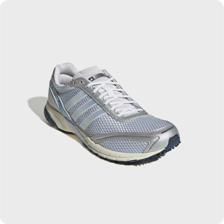 Adidas Adizero Adios - front three-quarter view showing silver metallic overlays, blue mesh upper and cream midsole