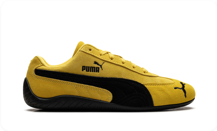 Puma Speedcat Saffron Yellow Black - side profile showing vibrant yellow suede upper with black Formstripe, Puma wordmark and black outsole
