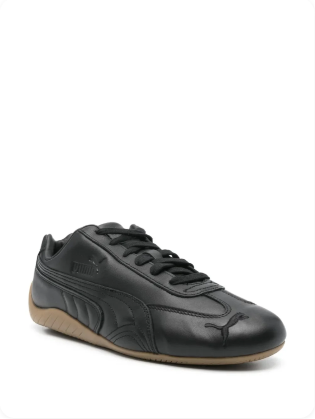 Puma Speedcat OG Black Gum - three-quarter front view showing all-black leather upper with tonal debossed Formstripe and gum outsole