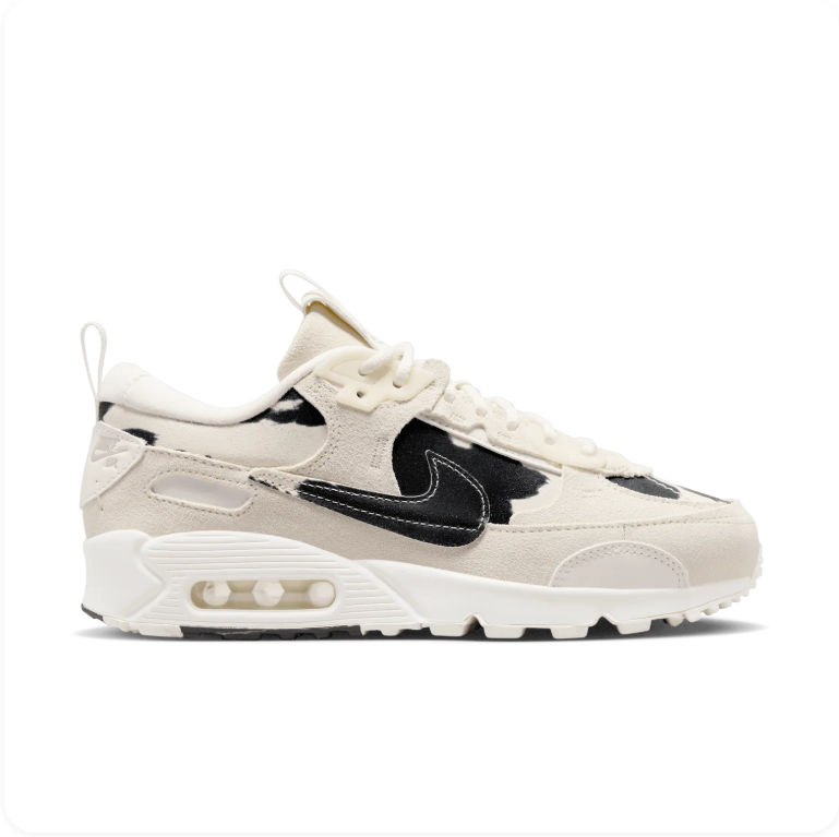 Nike Air Max 90 Futura Sail Black Cow Print - side profile showing cream suede upper, cow-print patent overlays and oversized black Swoosh