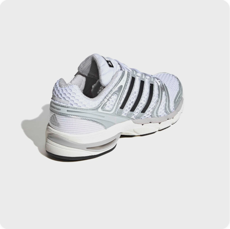 Adidas Spiritain - rear three-quarter view showing honeycomb heel panel, black Three Stripes and white midsole
